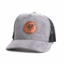 Load image into Gallery viewer, Royal Tyrrell Death Pose Brown Leather Patch on Adult Suede/Mesh Trucker Hat
